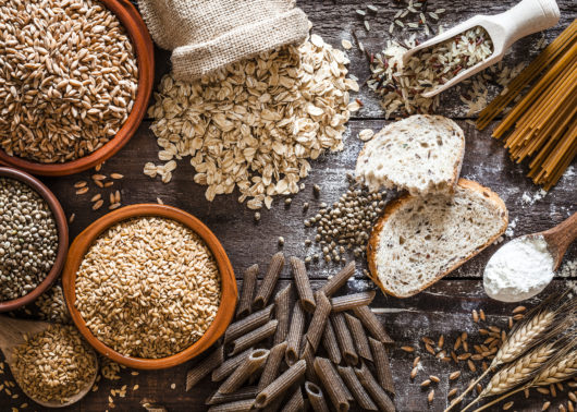 Grains, seeds, bread and pasta on a wooden table