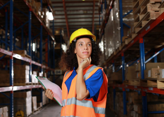 Factory worker woman holding a clipboard